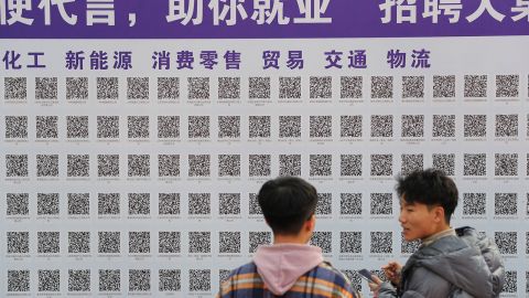 University students scan QR codes to search for employment opportunities during a job fair at Shandong University of Science and Technology on November 16, 2021 in Qingdao, Shandong Province of China.