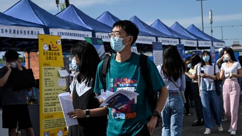 The photo taken on August 26, 2022 shows people attending a job fair in Beijing. 