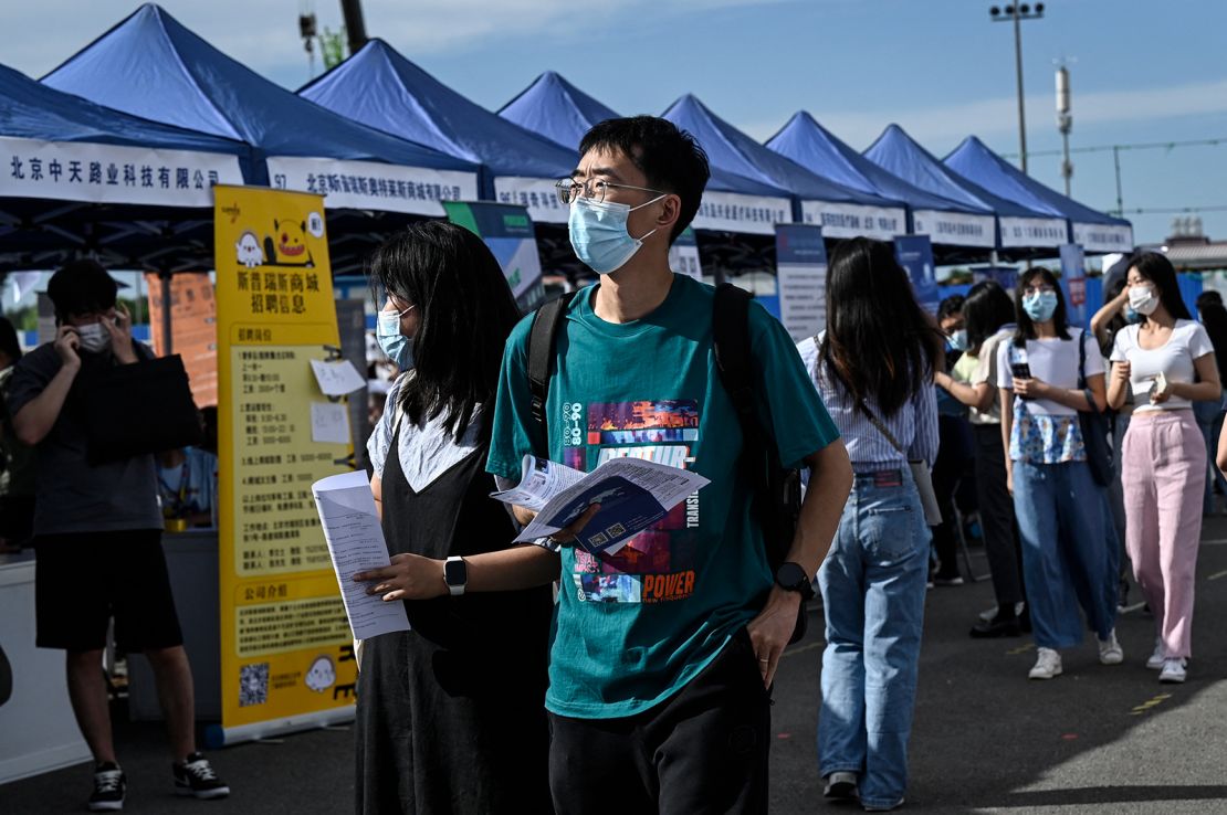 The photo taken on August 26, 2022 shows people attending a job fair in Beijing. 