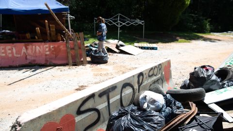 A member of Defend the Atlanta Forest walks near the entrance to Intrenchment Creek Park in Atlanta, Georgia, on August 3, 2022.