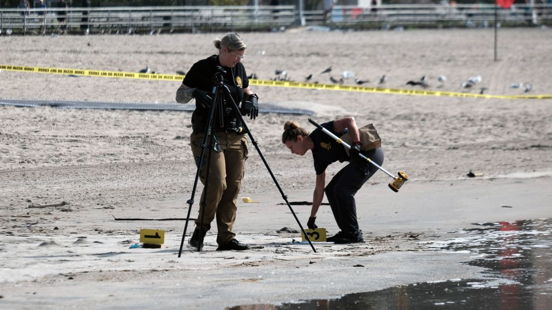 Police work where the children were found on the shoreline.