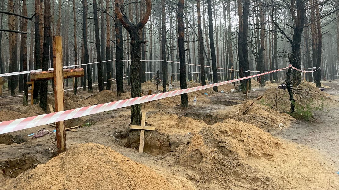 Individual graves are seen throughout the site in Izium.