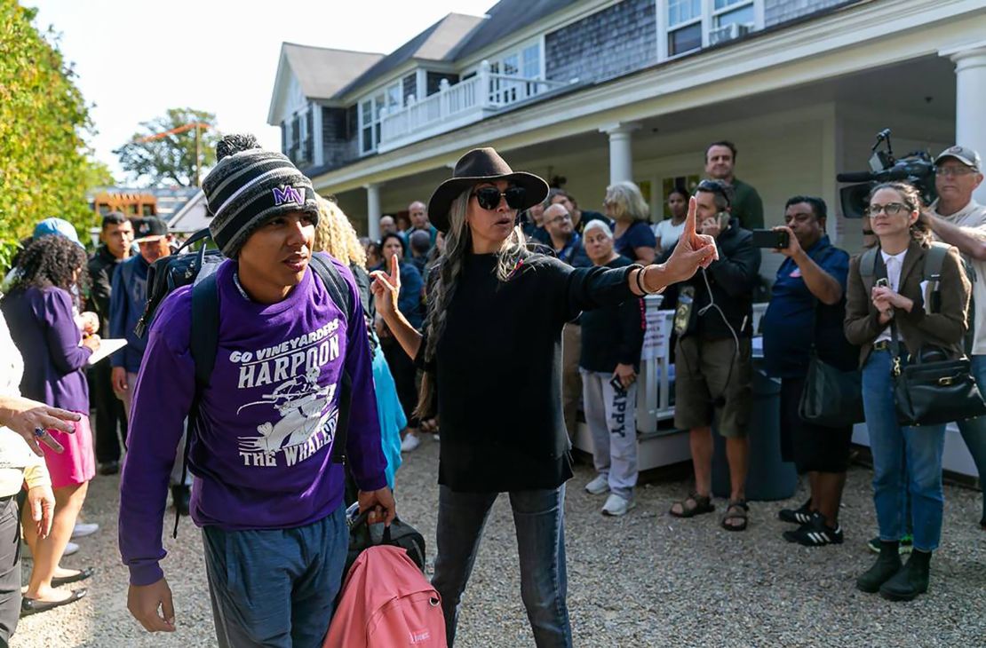 A Venezuelan migrant is led onto a bus Friday in Edgartown, Martha's Vineyard.