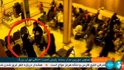 A video, broadcast by Iranian state TV, shows the alleged moment when 22-year-old Mahsa Amini, facing the camera in the red circle, collapses after being arrested by Iran. 