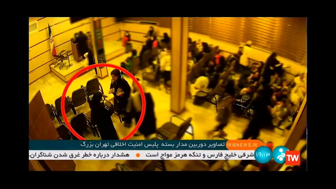 A video, released by Iranian state TV, shows the alleged moment that 22 year-old Mahsa Amini, facing the camera in the red circle, collapses after being arrested by Iran's "morality police."