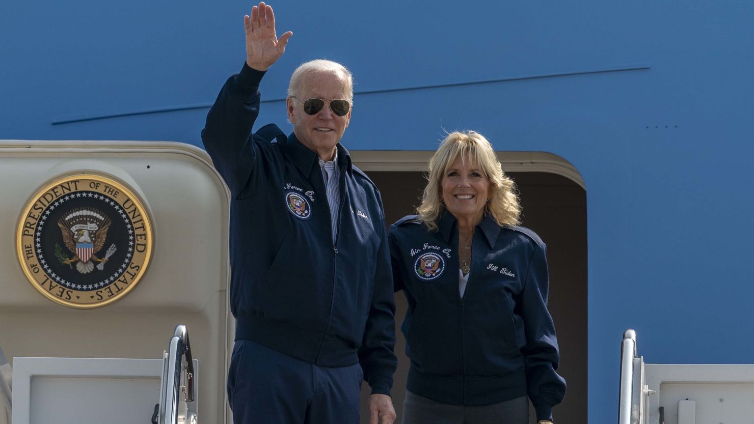 President Joe Biden, here with first lady Jill Biden, waves atop of the steps of Air Force One at Joint Base Andrews in Maryland on September 17, 2022, before their departure for London.