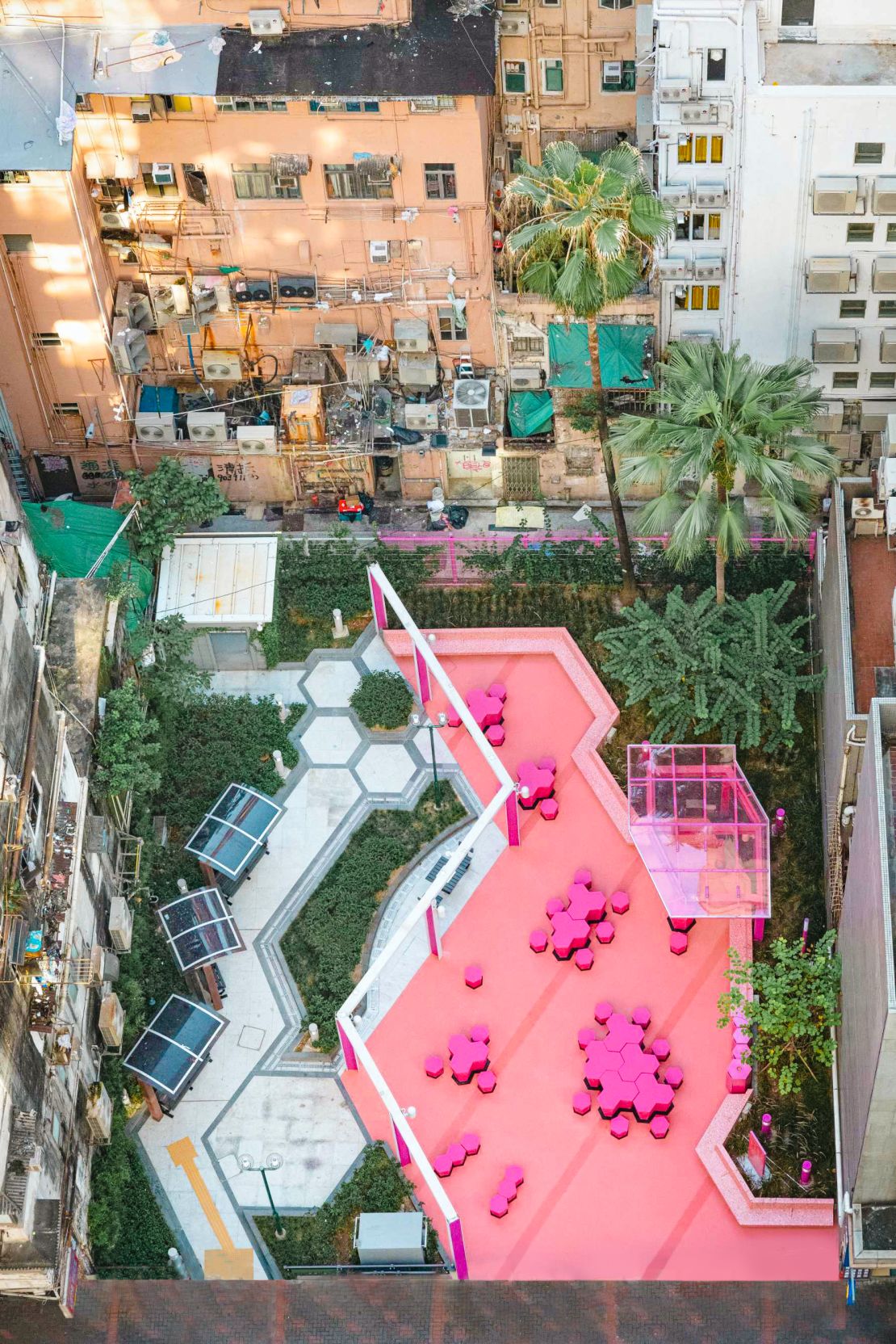 The designers split Portland Street Rest Garden down the middle, restoring one side in the style of a 1980s park, while the other was given a bright pink look. 