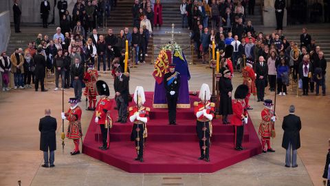 Grandsons of Queen Elizabeth II hold a watch near their grandmother's coffin in the state at Westminster Hall on Saturday.
