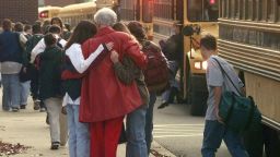 Students arriving at Heath High School in West Paducah, Ky., embrace on Tuesday, Dec. 2, 1997.