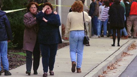 Parents gather outside Heath High School after the shooting.