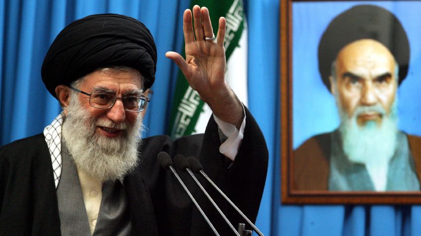 A handout photo provided by Iran's Supreme Leader's office shows Iranian supreme leader Ayatollah Ali Khamenei waving next to a portrait of Iran's late founder of Islamic Republic, Ayatollah Ruhollah Khomeini during Friday prayers sermon at Tehran University on February 3, 2012. Khamenei said that Iran has its "own threats" to respond to any military attack or sanctions against its oil exports. AFP PHOTO/HO/KHANENEI.IR ++ RESTRICTED TO EDITORIAL USE - MANDATORY CREDIT "AFP PHOTO / KHAMENEI.IR" - NO MARKETING NO ADVERTISING CAMPAIGNS - DISTRIBUTED AS A SERVICE TO CLIENTS ++ (Photo by - / KHAMENEI IR / AFP) (Photo by -/KHAMENEI IR/AFP via Getty Images)