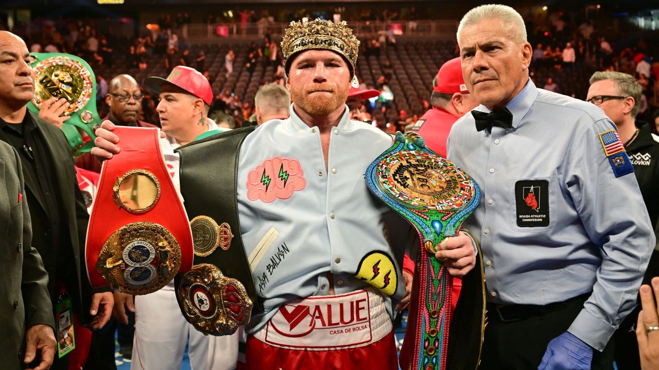 Álvarez poses with his belts and crown after defeating Golovkin.