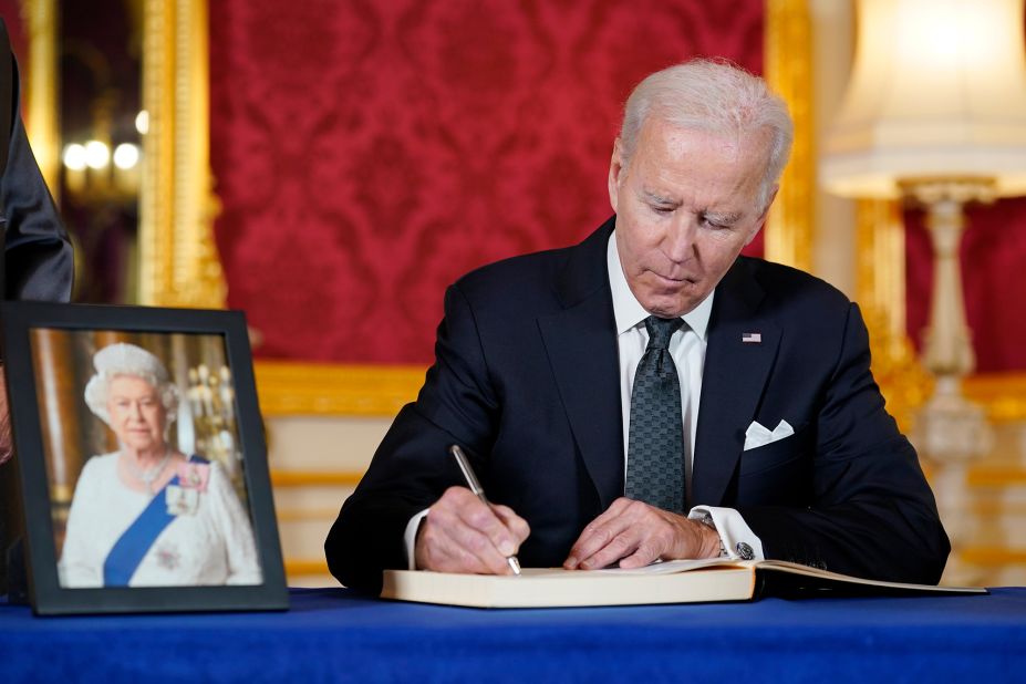 President Biden signs a book of condolences at London's Lancaster House on Sunday.