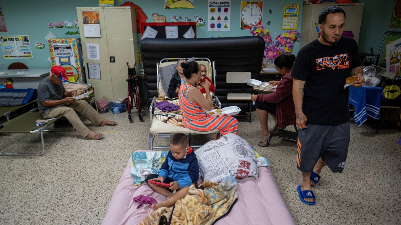 Evacuees are seen in a classroom of a public school being used as a shelter as Hurricane Fiona and its heavy rains approach in Guayanilla, Puerto Rico, on Sunday.
