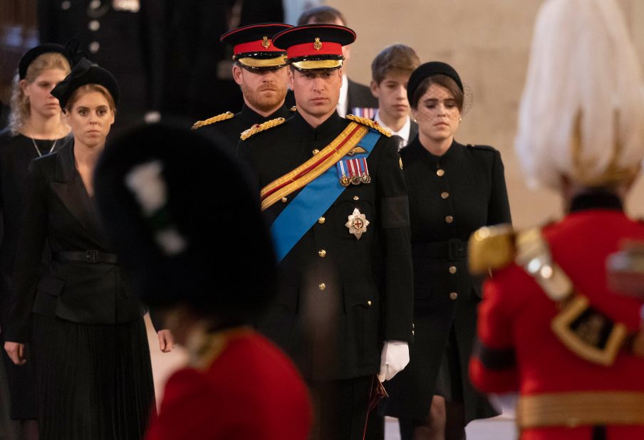 Prince William and Prince Harry lead the Queen's grandchildren into Westminster Hall to stand vigil at her coffin on Saturday.