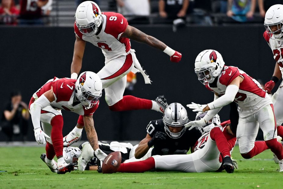 Arizona Cardinals cornerback Byron Murphy Jr., left, picks up a fumble and returns it for the winning touchdown during overtime of a dramatic 29-23 win against the Las Vegas Raiders on September 18. 