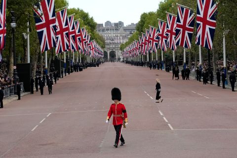A King's Guard soldier crosses The Mall outside Buckingham Palace before the Queen's funeral procession.