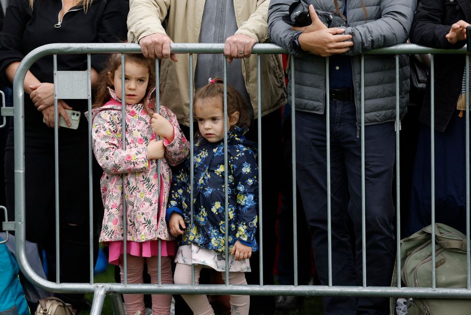 Children look through a fence in London, hoping to catch a glimpse of the procession.