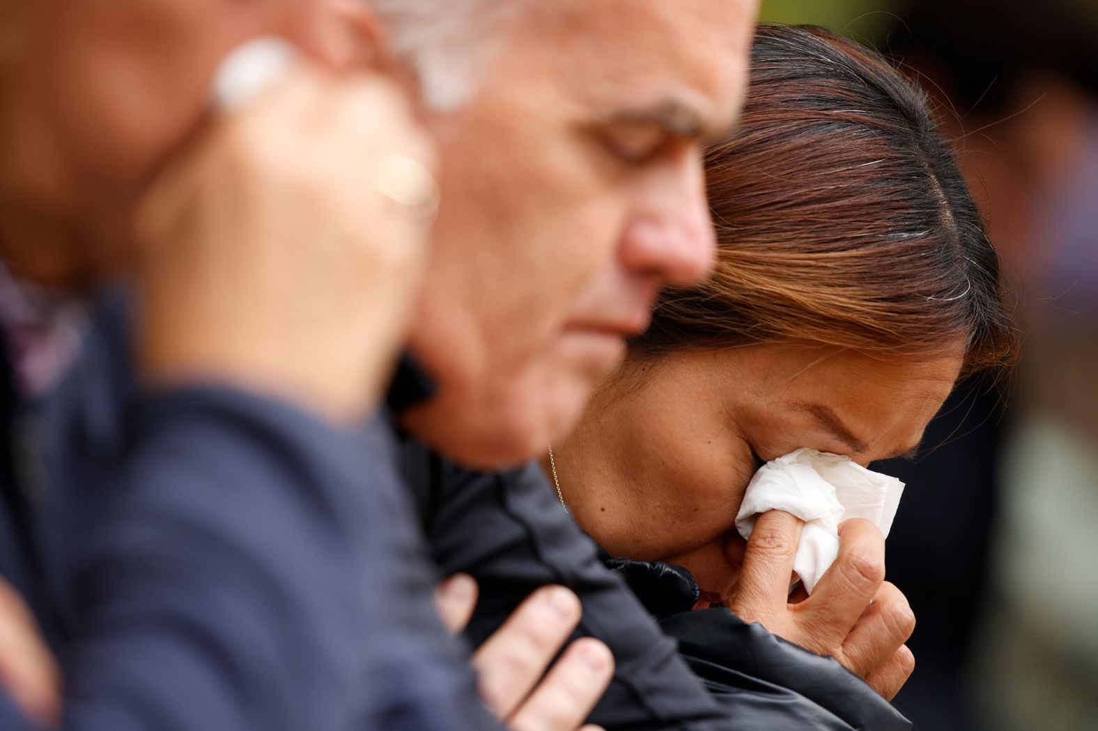 People cry during the funeral service.