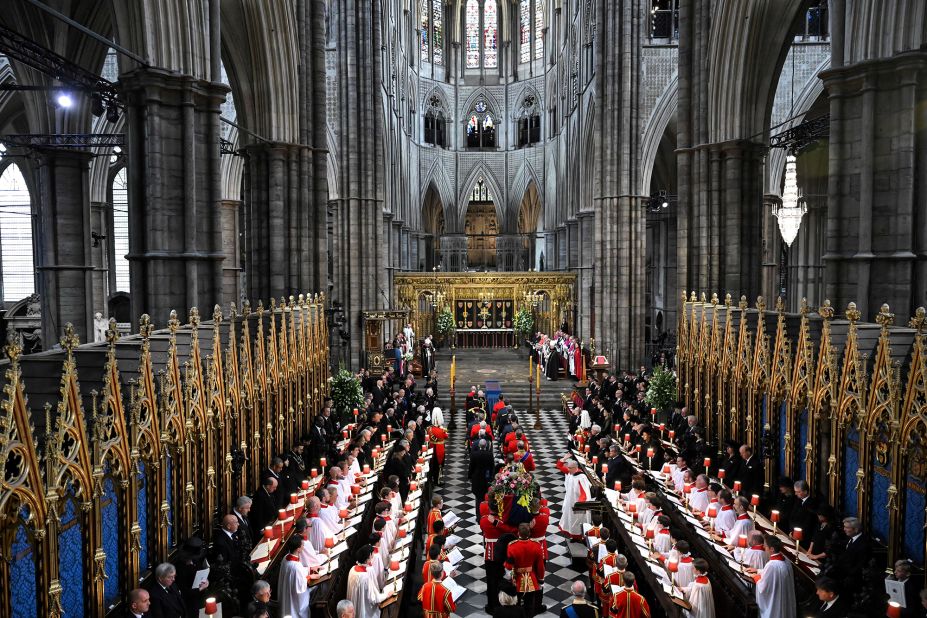 The Queen's coffin is carried into Westminster Abbey.