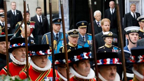 Prince William, Prince of Wales, Prince Richard, Duke of Gloucester, Prince Harry, Duke of Sussex, King Charles III, and Anne, Princess Royal walk alongside Yeoman of the Guards.