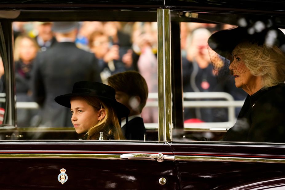 From left, Princess Charlotte, Prince George and Camilla, the Queen Consort, are seen in a vehicle outside Westminster Abbey.