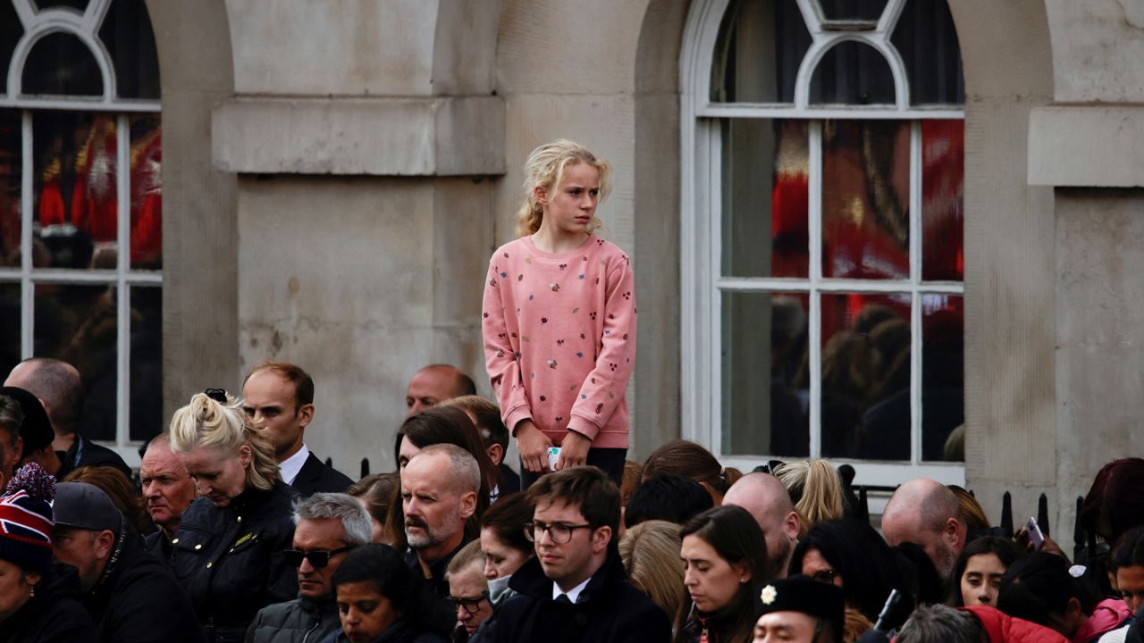 Mourners observe two minutes of silence outside Buckingham Palace.