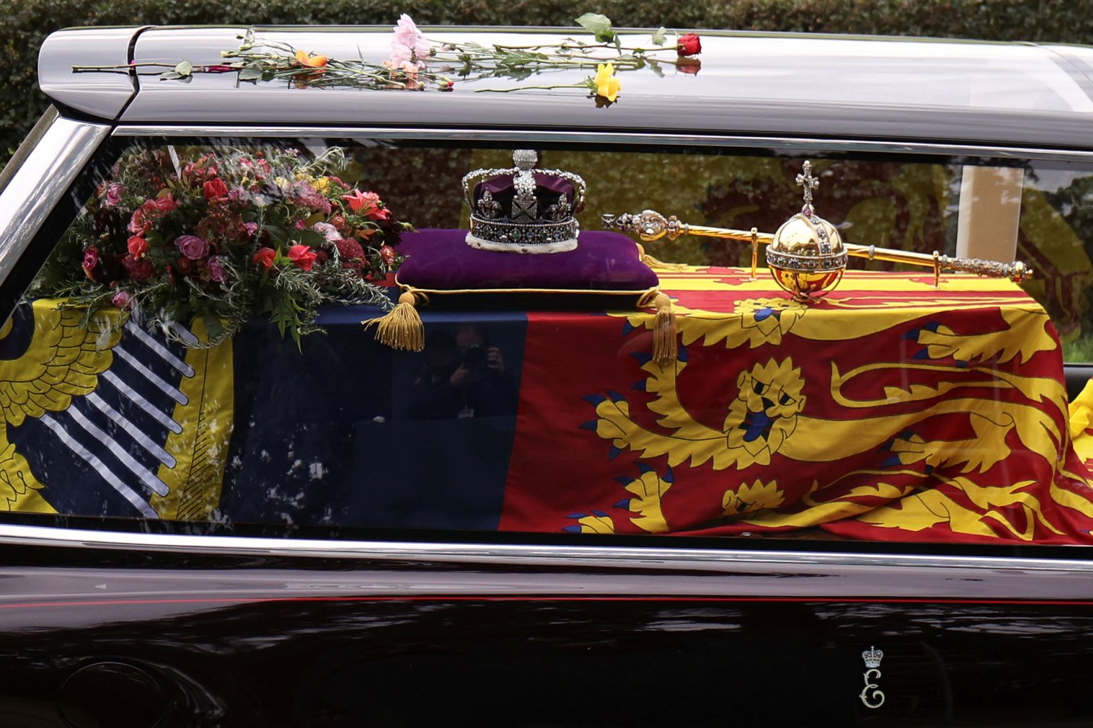 The Queen's coffin can be seen inside a hearse as it is driven along Albert Road in Windsor.