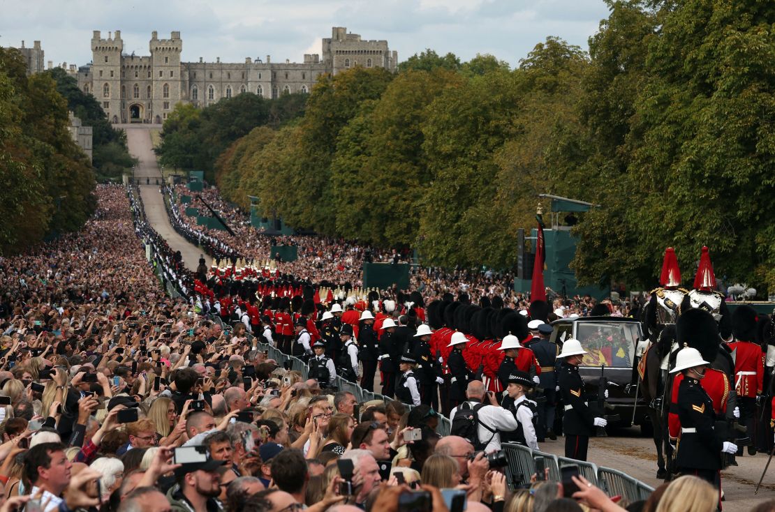 Crowds line the Long Walk outside Windsor Castle to watch the procession.