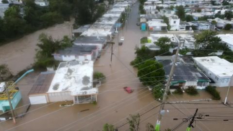 Cars and buildings are partially submerged in Puerto Rico, which remains lagely without power.