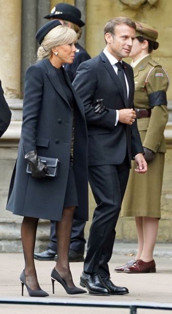 French President Emanuel Macron and wife Brigitte Macron arrive at the funeral along with other dignitaries. Brigitte Macron chose to wear a pillbox-style hat for the occasion.