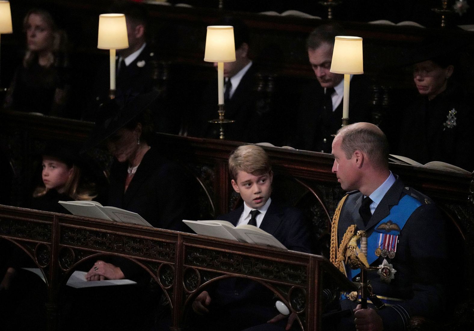 Prince William looks at his son Prince George as he attends the committal service with his wife Catherine, the Princess of Wales, and their daughter, Princess Charlotte.