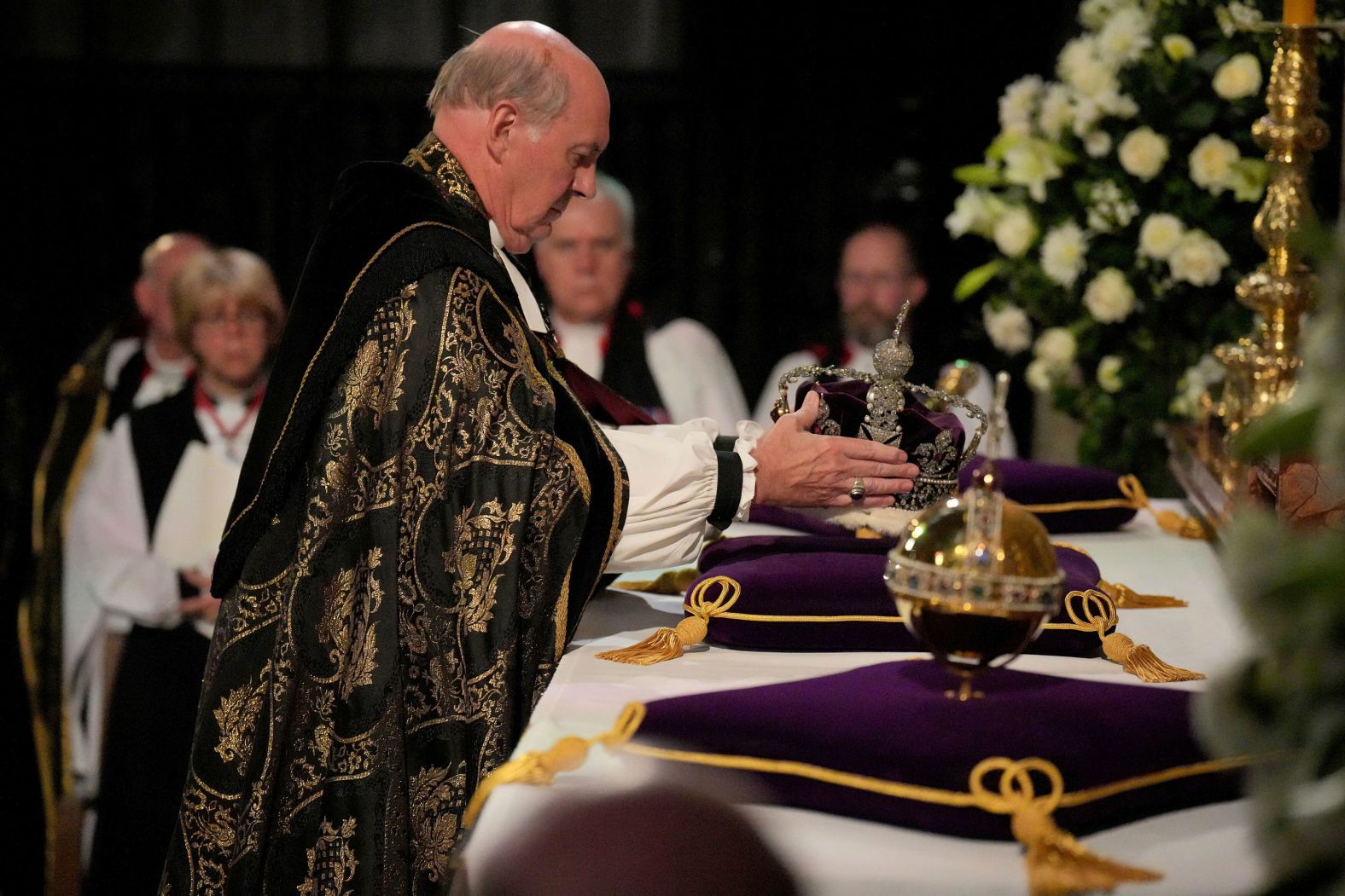 The Dean of Windsor, David Conner, places the Imperial State Crown and Orb and Sceptre on an altar during the committal service.