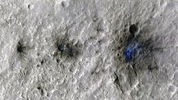 These craters were formed by a Sept. 5, 2021, meteoroid impact on Mars, the first to be detected by NASA's InSight. Taken by NASA's Mars Reconnaissance Orbiter, this enhanced-color image highlights the dust and soil disturbed by the impact in blue in order to make details more visible to the human eye.
