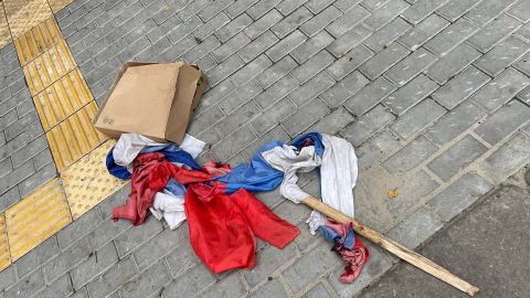 Two Russian flags, one with signs of being burnt, are seen outside of the detention center.