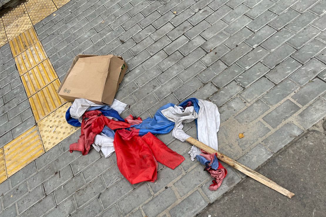 Two Russian flags, one with signs of being burnt, are seen outside of the detention center.