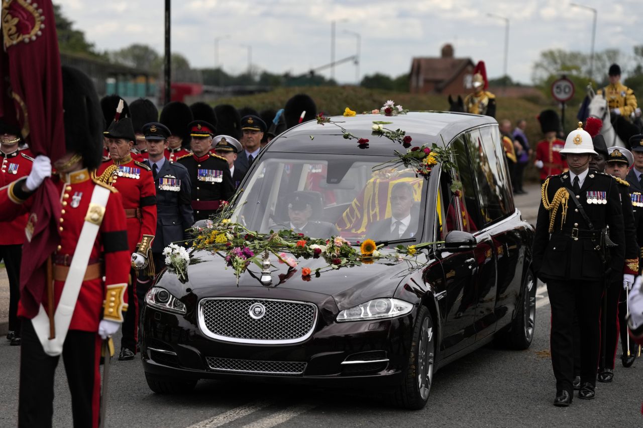 Flowers cover the hearse carrying the Queen's coffin.