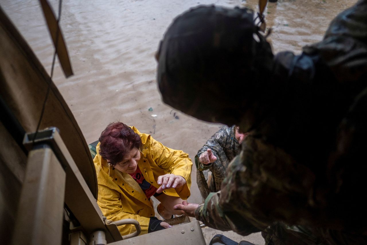 Members of the Puerto Rico National Guard rescue a woman stranded in her house in Salinas.
