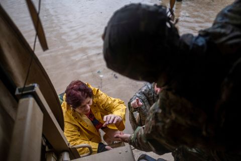 Members of the Puerto Rico National Guard rescue a woman stranded at her house in Salinas on Monday.