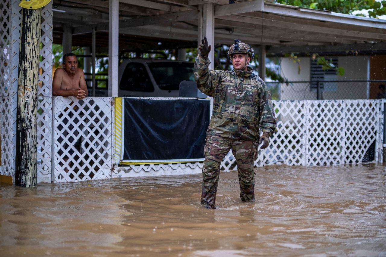 A member of the Puerto Rico National Guard searches for people to rescue in Salinas.