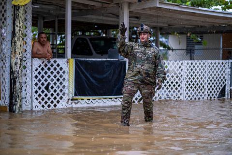 A Puerto Rican National Guard member searches for people to rescue in Salinas on Monday.