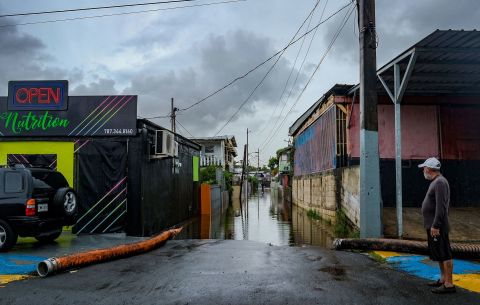 A man looks at a flooded street in the Juana Matos neighborhood of Cataño, Puerto Rico.