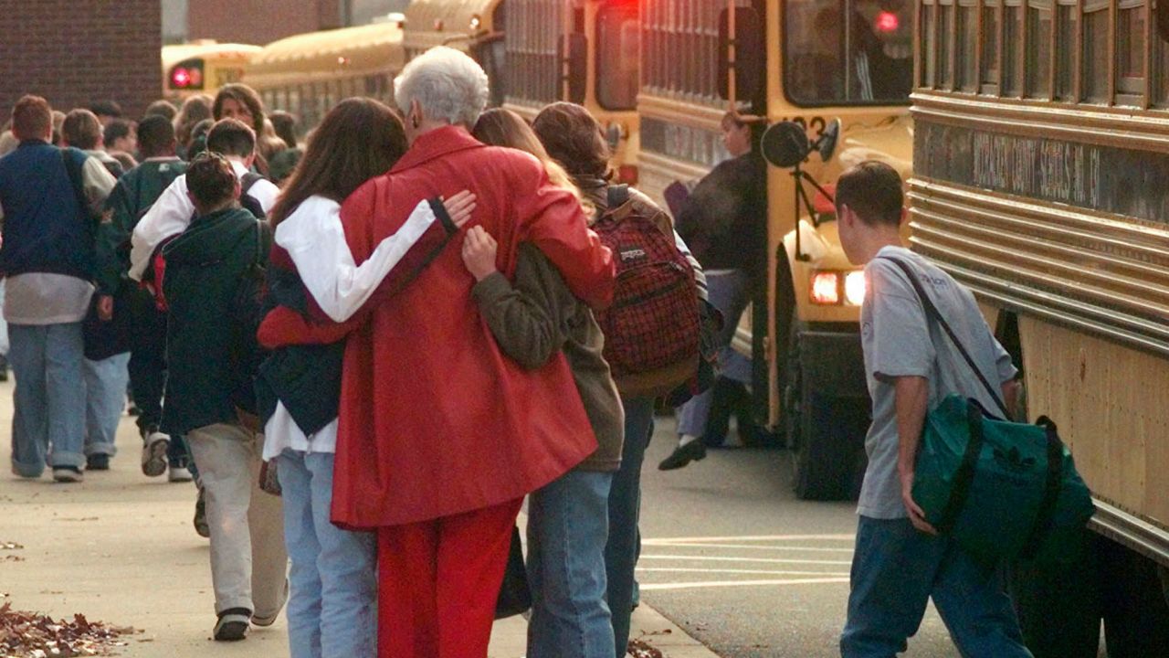 Students at Heath High School embrace the day after the mass shooting in December 1997.