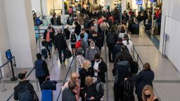 Passengers wait in line inside the terminal at Newark Liberty International Airport in Newark, New Jersey, U.S., November 24, 2021. REUTERS/Eduardo Munoz