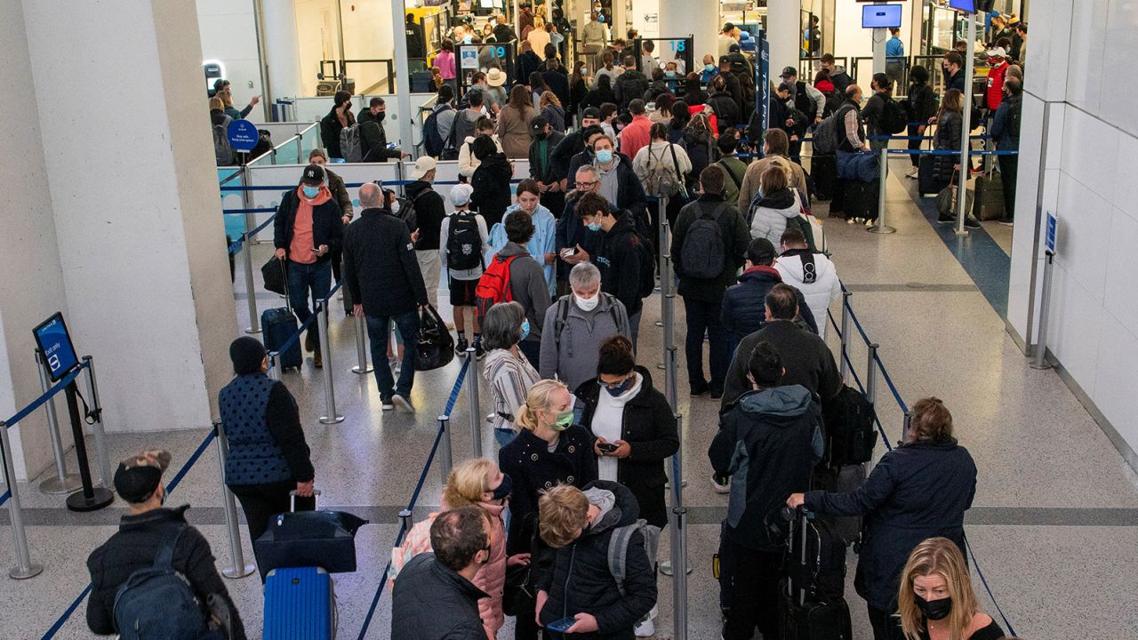Passengers wait in line inside the terminal at Newark Liberty International Airport on November 24, 2021. 