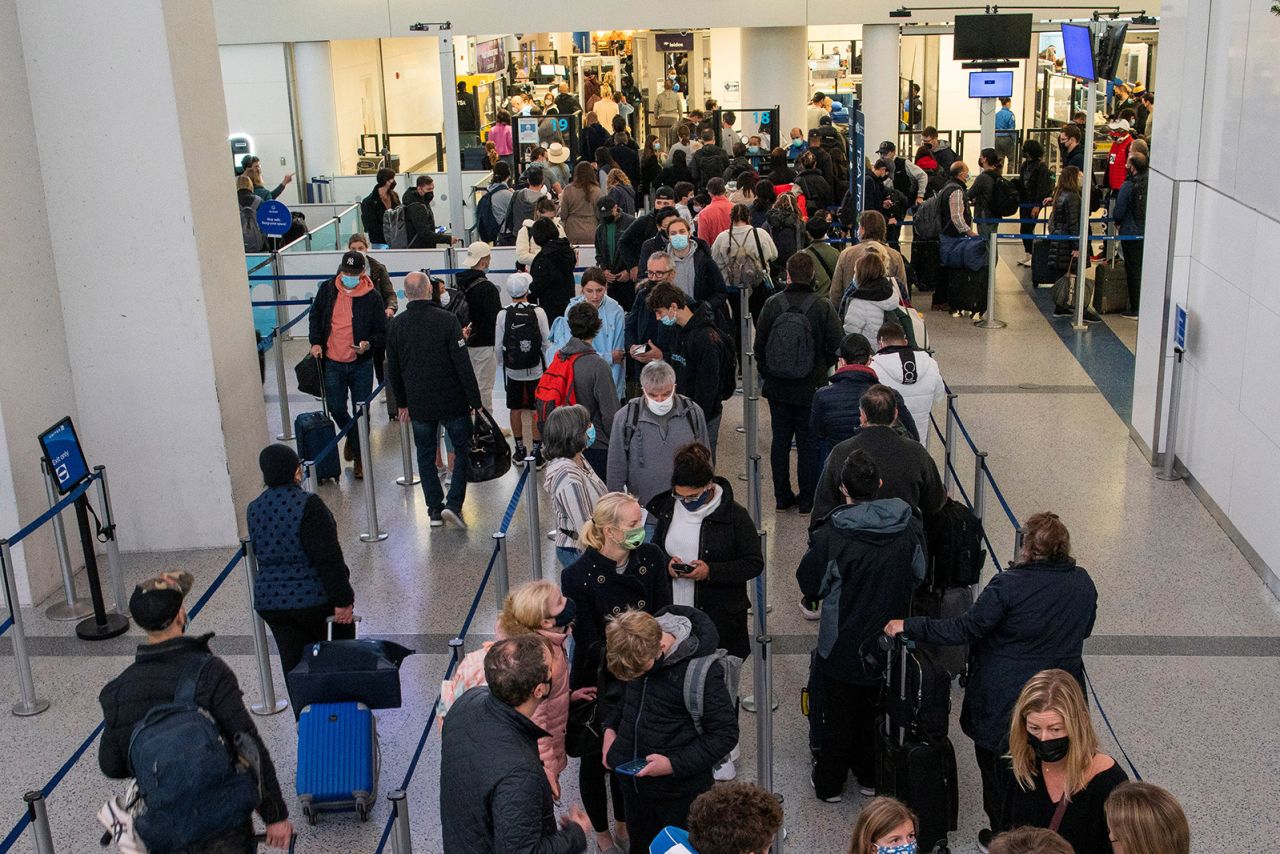Passengers wait in line inside the terminal at Newark Liberty International Airport on November 24, 2021.