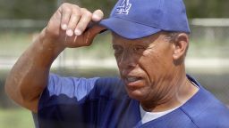 ** ADVANCE FOR WEEKEND EDITIONS, SEPT. 26-27 -- FILE -- ** In this Feb. 26, 2003 file photo, Los Angeles Dodgers bunting and base running coordinator Maury Wills adjusts his cap during spring training at Dodgertown in Vero Beach, Fla. Wills remembered back 43 years ago to that April night when he became the first batter to hit on artificial turf in a major league game. Even when the green rug was novel, he didn't like it.(AP Photo/Richard Drew, File)