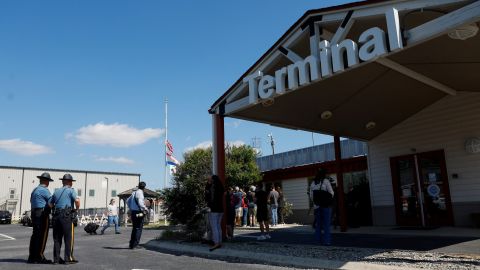 People gather outside of Delaware Coastal Airport on Tuesday in the wake of reports suggesting migrants will arrive there on a plane from Texas.