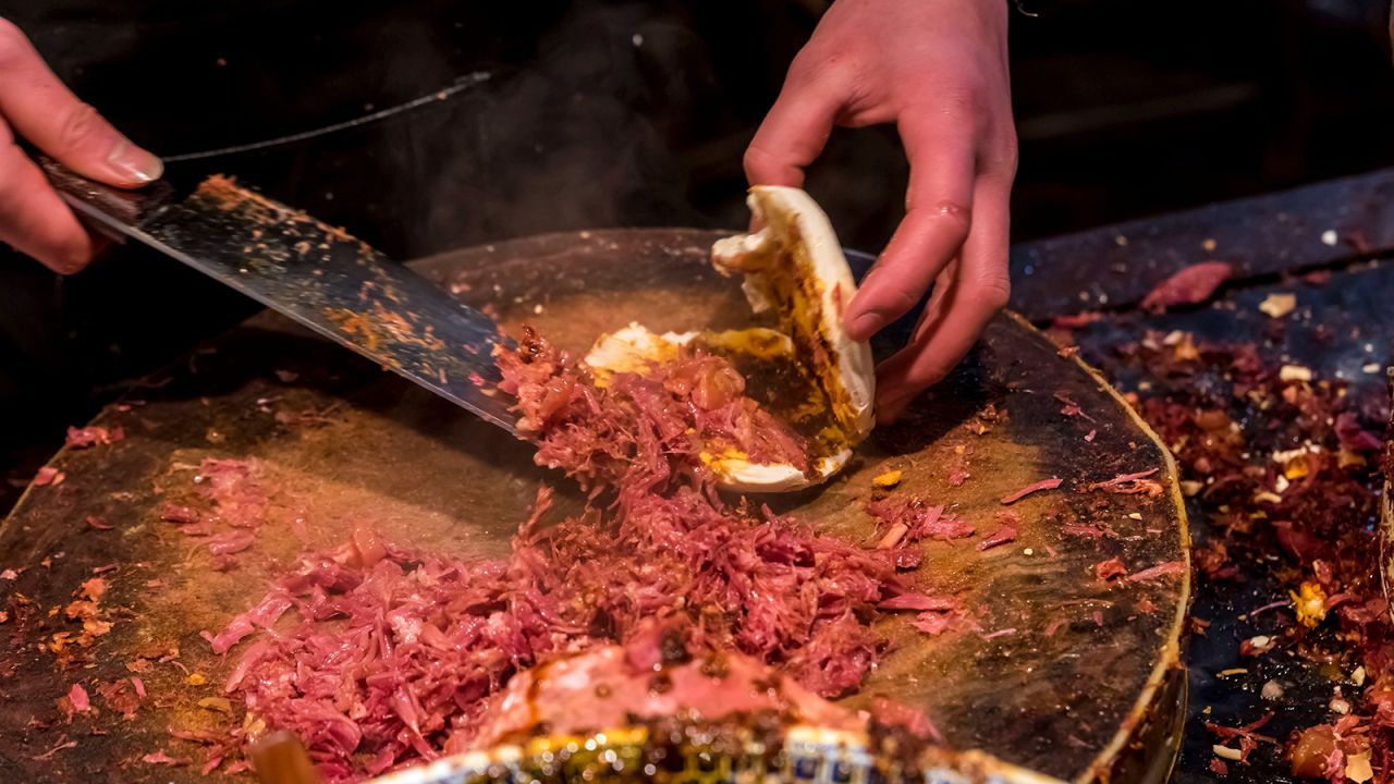 <strong>Rou jia mo:</strong> The ubiquitous street eat from Xi'An consists of a grilled <em>mo </em>(flat bread) and an overflowing amount of shredded pulled pork belly that has been braised in soy sauce, rock sugar and spices like cinnamon, star anise, cloves and peppercorns for hours. 