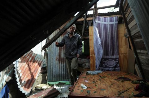 A man in El Seibo, Dominican Republic, looks at his damaged house on Tuesday.